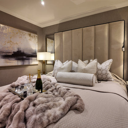 Custom Belle bed frame with a super high, panelled beige upholstered headboard in a luxe bedroom.